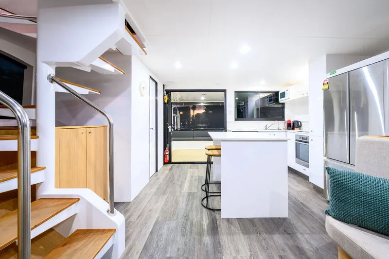 One Off Yacht Photos Pics Modern interior of 2019 Coral Coast 62 Power Catamaran with sleek kitchen and staircase.