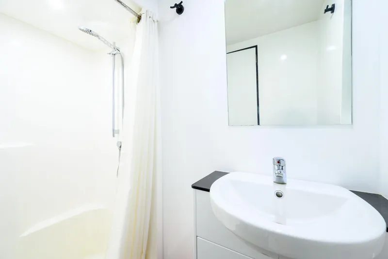 One Off Yacht Photos Pics Modern bathroom on 2019 Coral Coast 62 Power Catamaran with shower and sink.