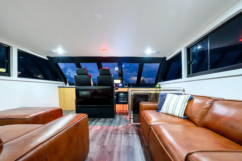 One Off Yacht Photos Pics Luxurious interior of 2019 Coral Coast 62 Power Catamaran with leather seating and modern helm.