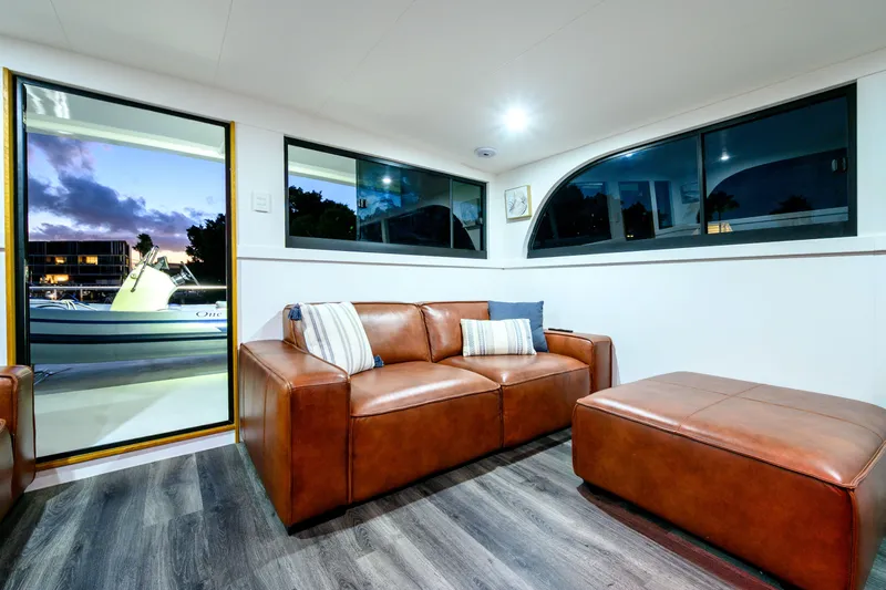 One Off Yacht Photos Pics Luxurious interior of 2019 Coral Coast 62 Power Catamaran with leather seating and scenic view.