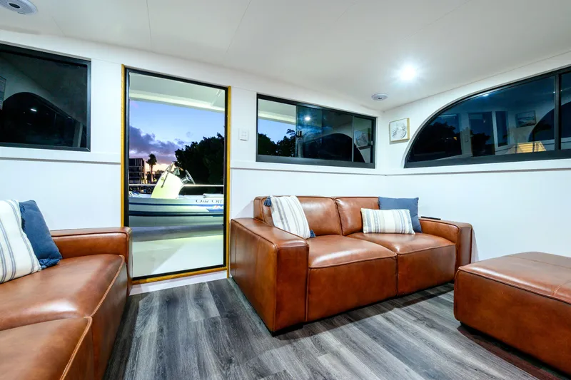 One Off Yacht Photos Pics Luxurious interior of 2019 Coral Coast 62 Power Catamaran with leather seating and scenic view.