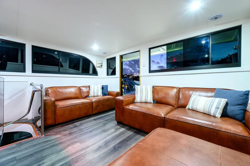 One Off Yacht Photos Pics Luxurious interior of 2019 Coral Coast 62 Power Catamaran with leather sofas and modern decor.