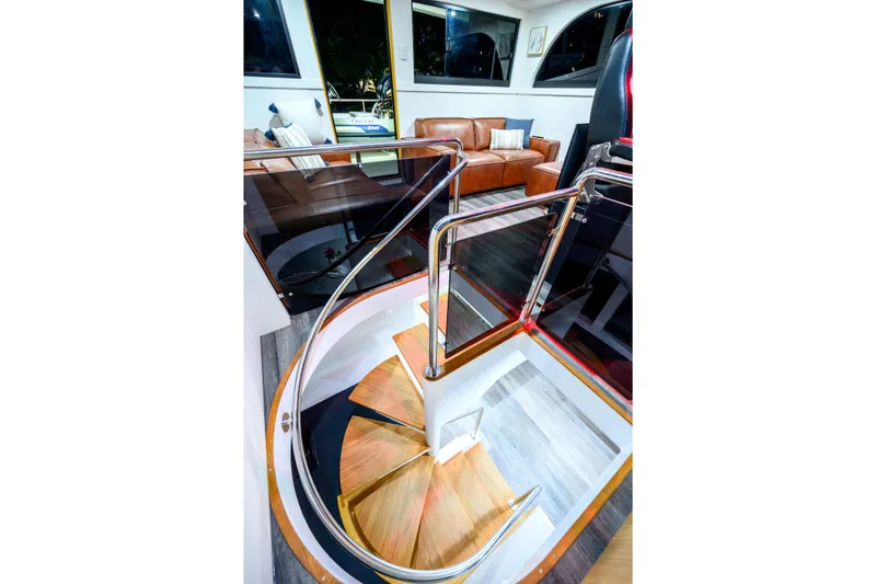 One Off Yacht Photos Pics Luxurious interior of 2019 Coral Coast 62 Power Catamaran with elegant staircase and leather seating.