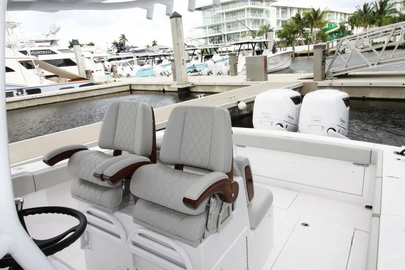  Yacht Photos Pics 2024 Jupiter 34 HFS boat interior with dual seats and twin outboard engines at marina.
