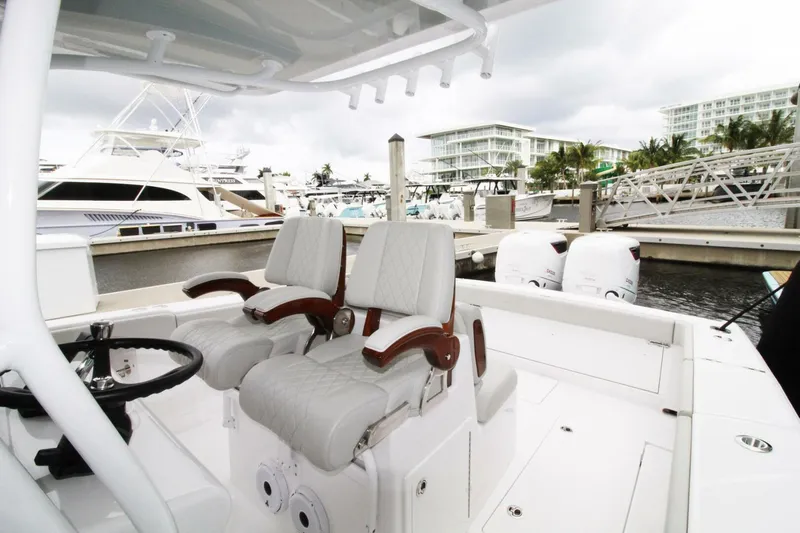  Yacht Photos Pics 2024 Jupiter 34 HFS boat interior with dual seats and marina background.