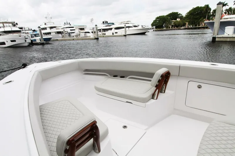  Yacht Photos Pics 2024 Jupiter 34 HFS boat interior with cushioned seating, docked near luxury yachts.