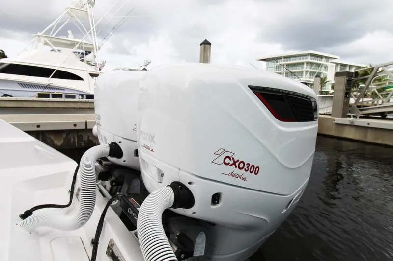  Yacht Photos Pics Twin CXO300 outboard engines on a 2024 Jupiter 34 HFS boat docked at a marina.