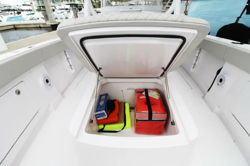  Yacht Photos Pics Open storage compartment on 2024 Jupiter 34 HFS boat with safety gear inside.
