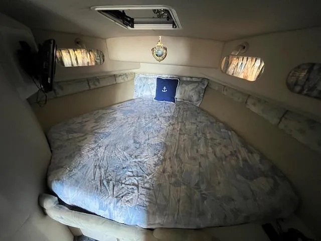 Papa's 7 II Yacht Photos Pics 1995 Sea Ray 440 Express Bridge cabin with bed, nautical decor, and small windows.