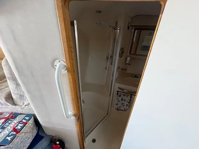 Papa's 7 II Yacht Photos Pics Bathroom interior of 1995 Sea Ray 440 Express Bridge yacht, featuring shower and sink.