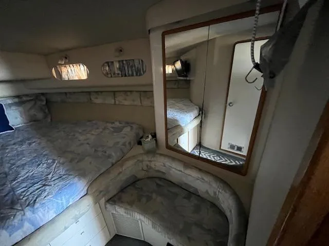 Papa's 7 II Yacht Photos Pics 1995 Sea Ray 440 Express Bridge cabin interior with bed, mirror, and seating area.
