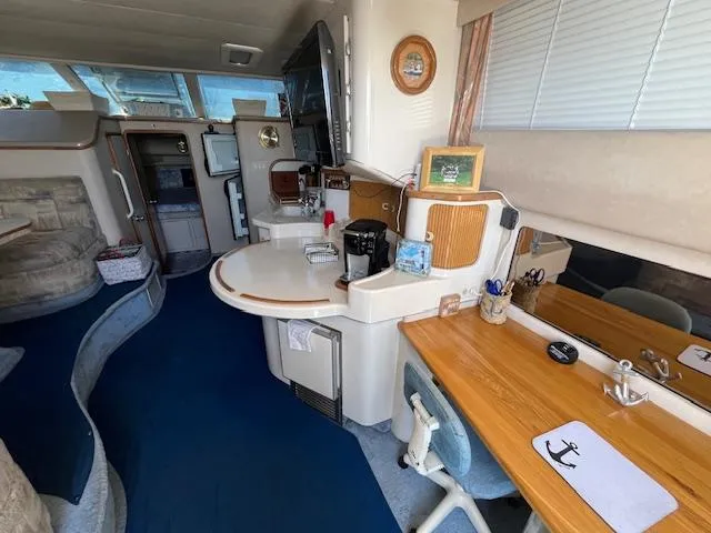 Papa's 7 II Yacht Photos Pics Interior of 1995 Sea Ray 440 Express Bridge with kitchen and seating area.