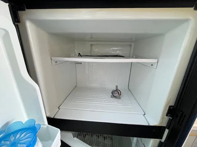 Papa's 7 II Yacht Photos Pics Empty refrigerator interior with a thermometer, Sea Ray 440 Express Bridge, 1995 model.