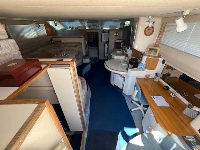 Papa's 7 II Yacht Photos Pics Interior of 1995 Sea Ray 440 Express Bridge yacht, featuring cozy living and dining areas.