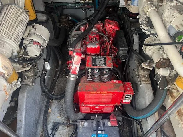 Papa's 7 II Yacht Photos Pics Engine compartment of a 1995 Sea Ray 440 Express Bridge, featuring a red engine.