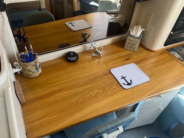 Papa's 7 II Yacht Photos Pics Wooden desk with anchor-themed decor in a 1995 Sea Ray 440 Express Bridge yacht.