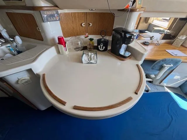 Papa's 7 II Yacht Photos Pics 1995 Sea Ray 440 Express Bridge interior with kitchenette and coffee maker.