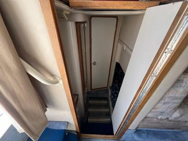 Papa's 7 II Yacht Photos Pics Interior view of 1995 Sea Ray 440 Express Bridge, featuring a narrow hallway and door.