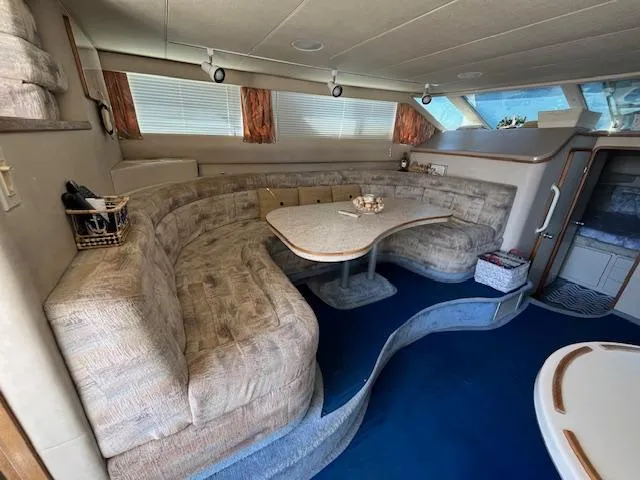 Papa's 7 II Yacht Photos Pics Interior of 1995 Sea Ray 440 Express Bridge with plush seating and dining area.