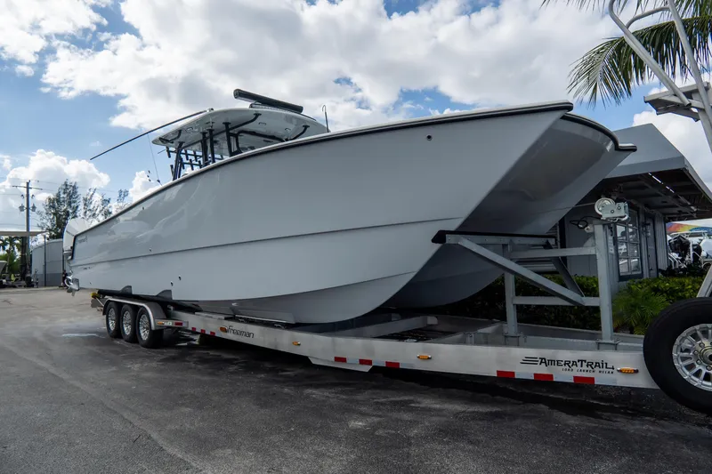  Yacht Photos Pics 2024 Freeman 38 boat on trailer under a cloudy sky.