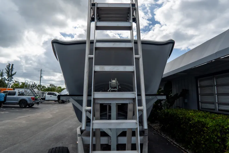  Yacht Photos Pics 2024 Freeman 38 boat on trailer, viewed from front with ladder, cloudy sky background.