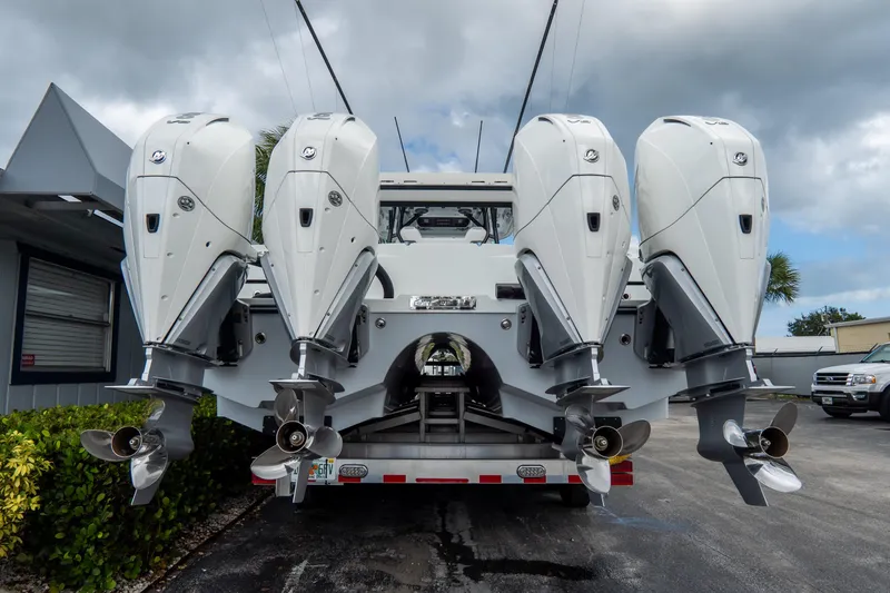  Yacht Photos Pics 2024 Freeman 38 boat with four powerful outboard engines, parked on a trailer.