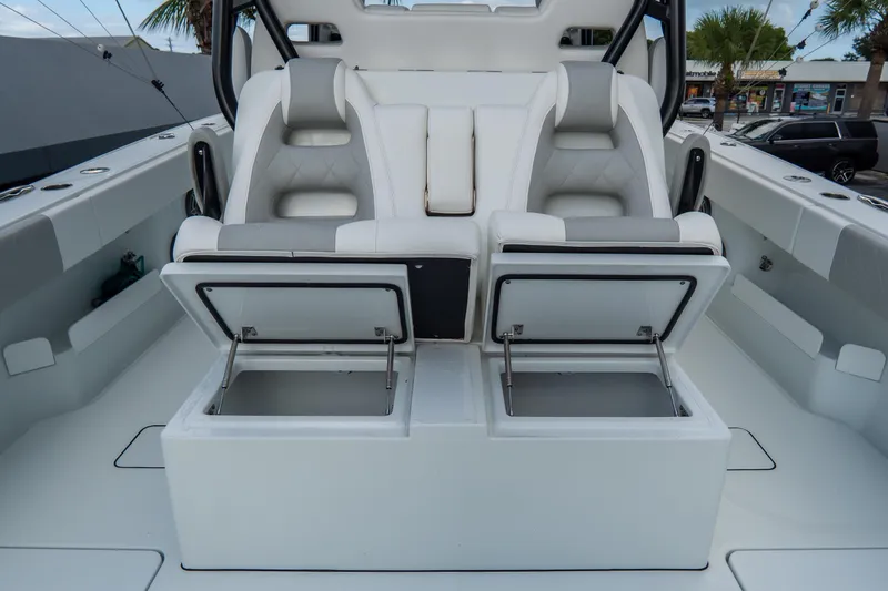  Yacht Photos Pics Luxury seating and storage on 2024 Freeman 38 boat, featuring sleek white and gray design.