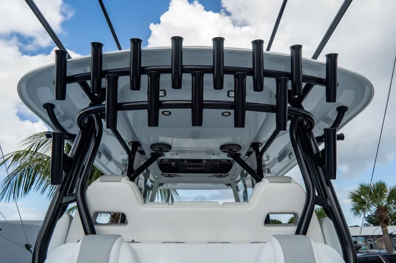  Yacht Photos Pics 2024 Freeman 38 boat interior with rod holders and white seating under a blue sky.