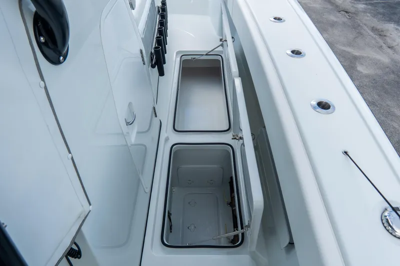  Yacht Photos Pics 2024 Freeman 38 boat storage compartments with open lids, showcasing spacious interior design.