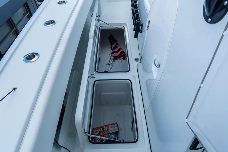  Yacht Photos Pics 2024 Freeman 38 boat storage compartments with American flag and snacks.