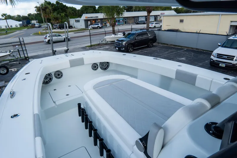  Yacht Photos Pics 2024 Freeman 38 boat interior with seating, rod holders, and speakers in a parking lot setting.