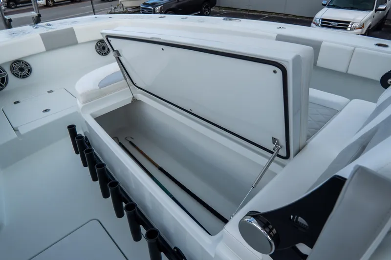  Yacht Photos Pics Open storage compartment on 2024 Freeman 38 boat, featuring rod holders and seating.