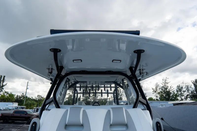  Yacht Photos Pics 2024 Freeman 38 boat with sleek design and modern canopy, under a cloudy sky.