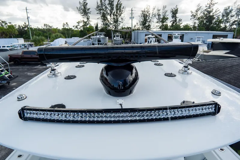  Yacht Photos Pics 2024 Freeman 38 boat deck with radar and LED light bar, surrounded by parked vehicles.