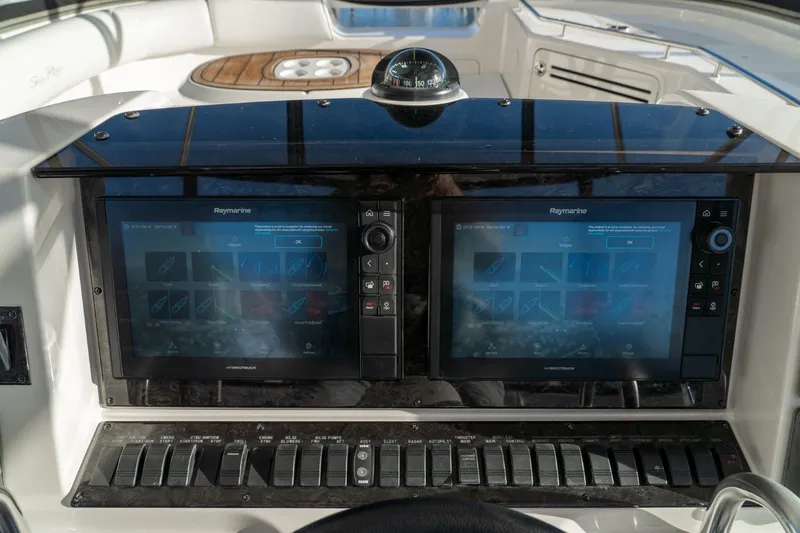  Yacht Photos Pics 2008 Sea Ray 58 Sedan Bridge helm with dual Raymarine displays and control panel.