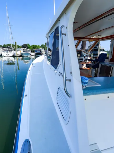  Yacht Photos Pics 2004 True North 38 boat docked at marina, interior view of helm and seating.