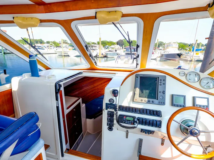  Yacht Photos Pics Interior of 2004 True North 38 boat with navigation equipment and marina view.