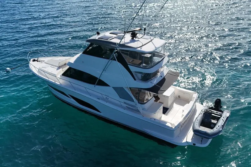  Yacht Photos Pics 2021 Riviera 50 Sports Motor Yacht on clear blue water, aerial view.