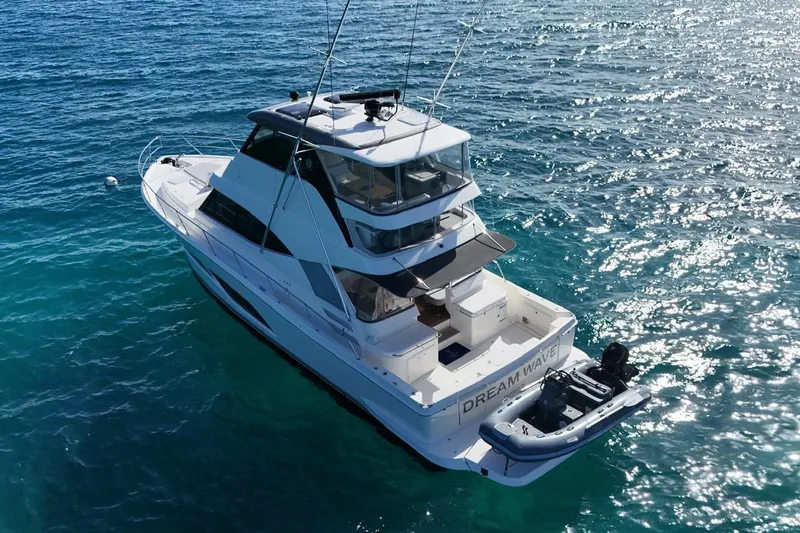  Yacht Photos Pics 2021 Riviera 50 Sports Motor Yacht on clear blue water, aerial view.