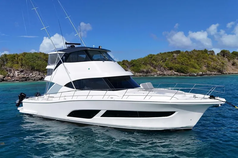  Yacht Photos Pics 2021 Riviera 50 Sports Motor Yacht cruising near a scenic island.