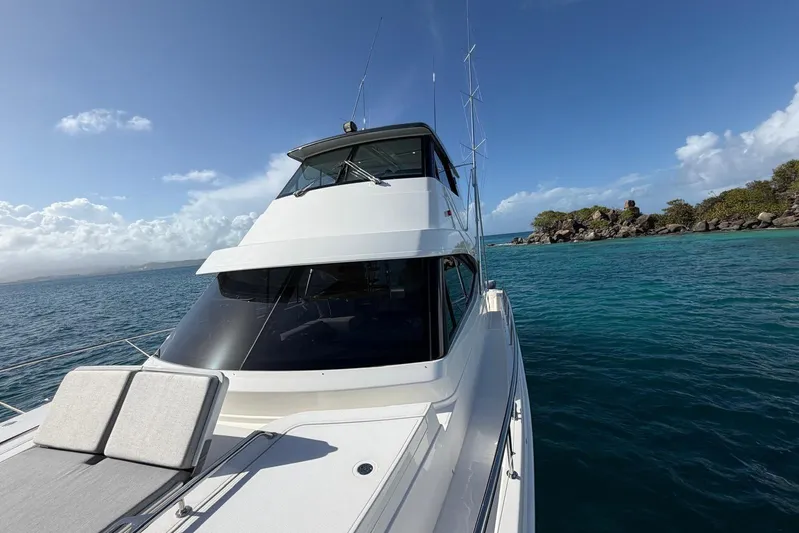  Yacht Photos Pics 2021 Riviera 50 Sports Motor Yacht cruising in clear blue waters.