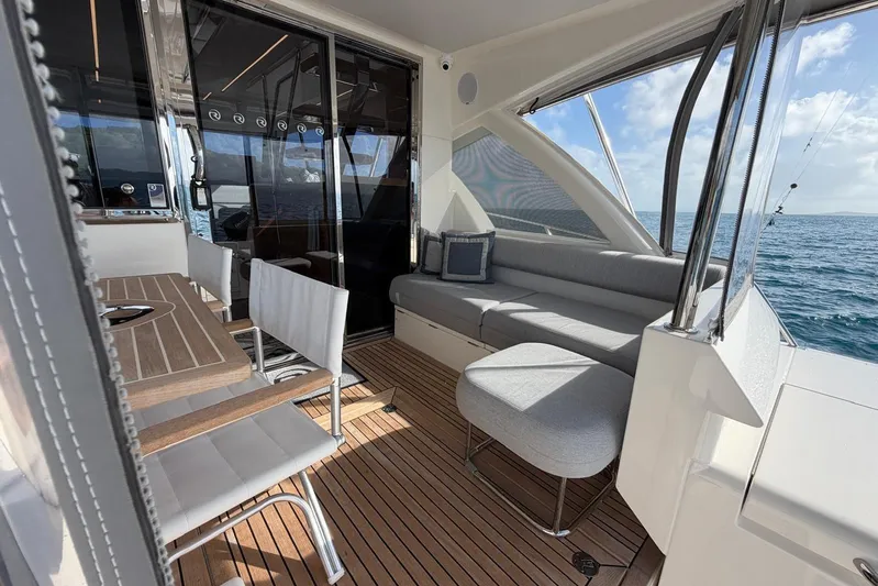  Yacht Photos Pics Luxurious 2021 Riviera 50 Sports Motor Yacht interior with elegant seating and ocean view.