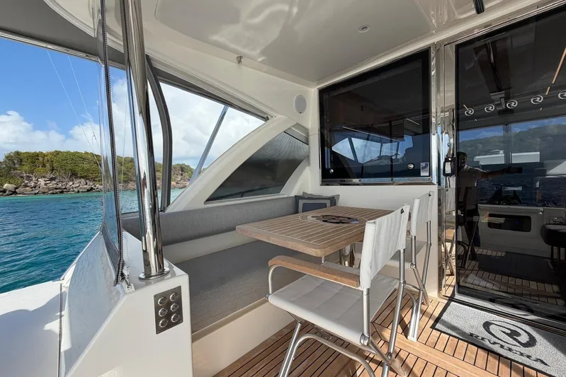  Yacht Photos Pics 2021 Riviera 50 Sports Motor Yacht interior with dining area and ocean view.