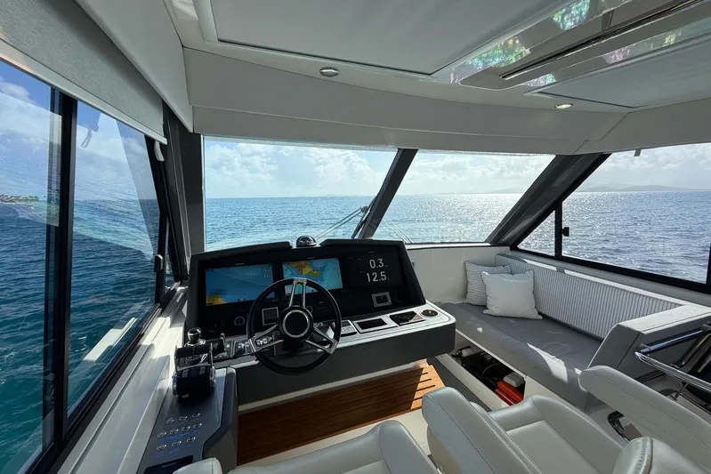  Yacht Photos Pics Interior view of 2021 Riviera 50 Sports Motor Yacht helm with ocean backdrop.