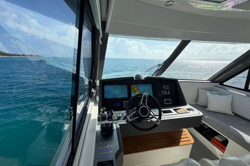  Yacht Photos Pics Interior view of 2021 Riviera 50 Sports Motor Yacht helm with ocean backdrop.