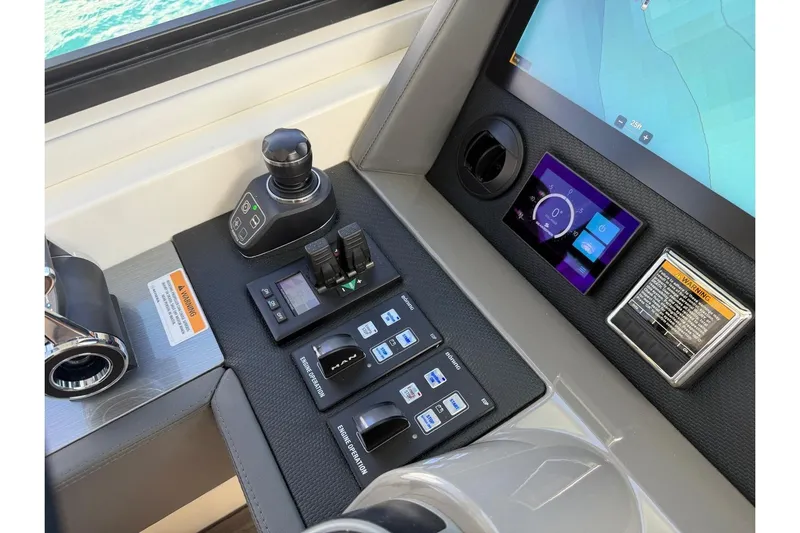  Yacht Photos Pics Control panel of 2021 Riviera 50 Sports Motor Yacht with navigation and engine controls.