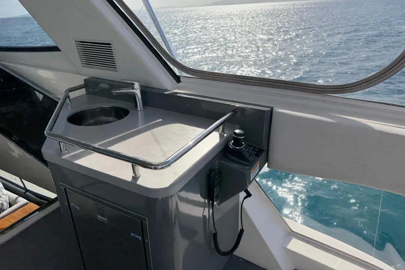  Yacht Photos Pics Interior view of 2021 Riviera 50 Sports Motor Yacht with sink and control panel.