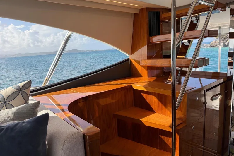  Yacht Photos Pics Interior of 2021 Riviera 50 Sports Motor Yacht with wooden stairs and ocean view.