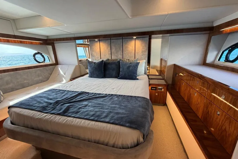  Yacht Photos Pics Luxurious bedroom interior of 2021 Riviera 50 Sports Motor Yacht with ocean view.