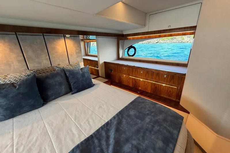  Yacht Photos Pics Luxurious bedroom interior of 2021 Riviera 50 Sports Motor Yacht with ocean view.